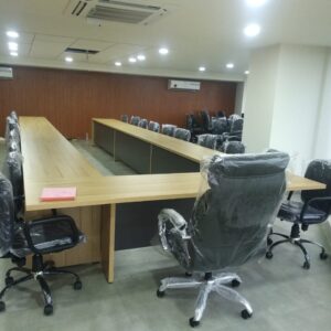 Modern U-shaped conference table with wooden finish, ideal for meetings and collaborative workspaces.